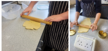 A person rolling out dough on a counter