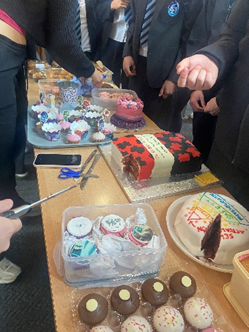 a display of cakes on a table at the bake sale