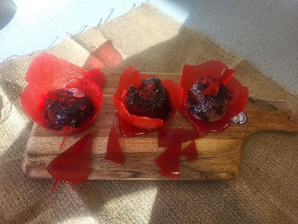 three cakes in a red wrapping case