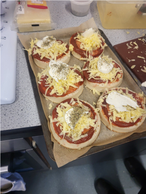 A tray of pizzas with cheese and sauce