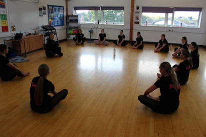 A group of students sitting on the floor