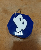 A blue and white keychain with a white letter on it
