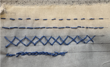 A close up of a fabric with blue stitching