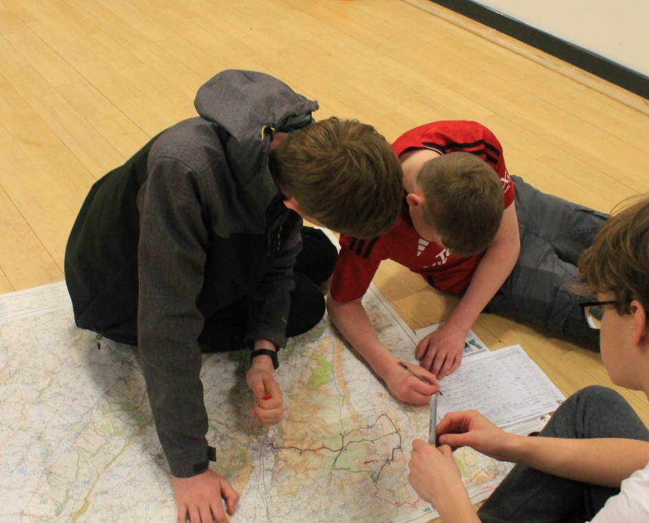 Three students looking at a map
