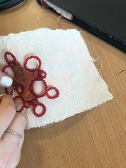 a hand embroidering