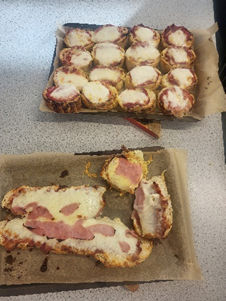 Image of two trays of pizza cooked in lessons