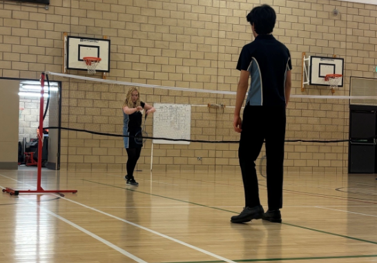 two students playing badminton