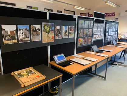 A photography classroom with tables and books displaying the A Level work