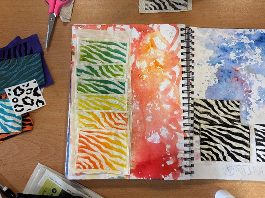 A sketchbook with different colors of paint