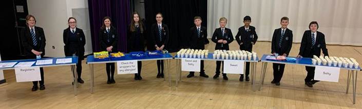 Students serving pop corn at the Christmas Rewards Event 