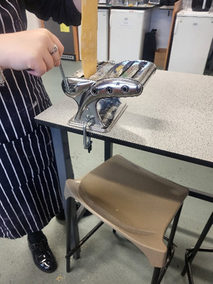 student using a pasta machine