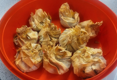 8 filo pastry parcels in a  red tin