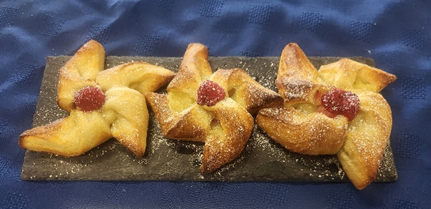 three star shaped pastries on a board