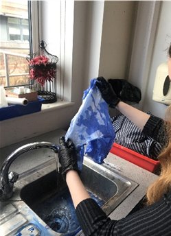 two hands holding a  tie-dye cloth