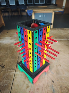 A colorful wooden object with sticks