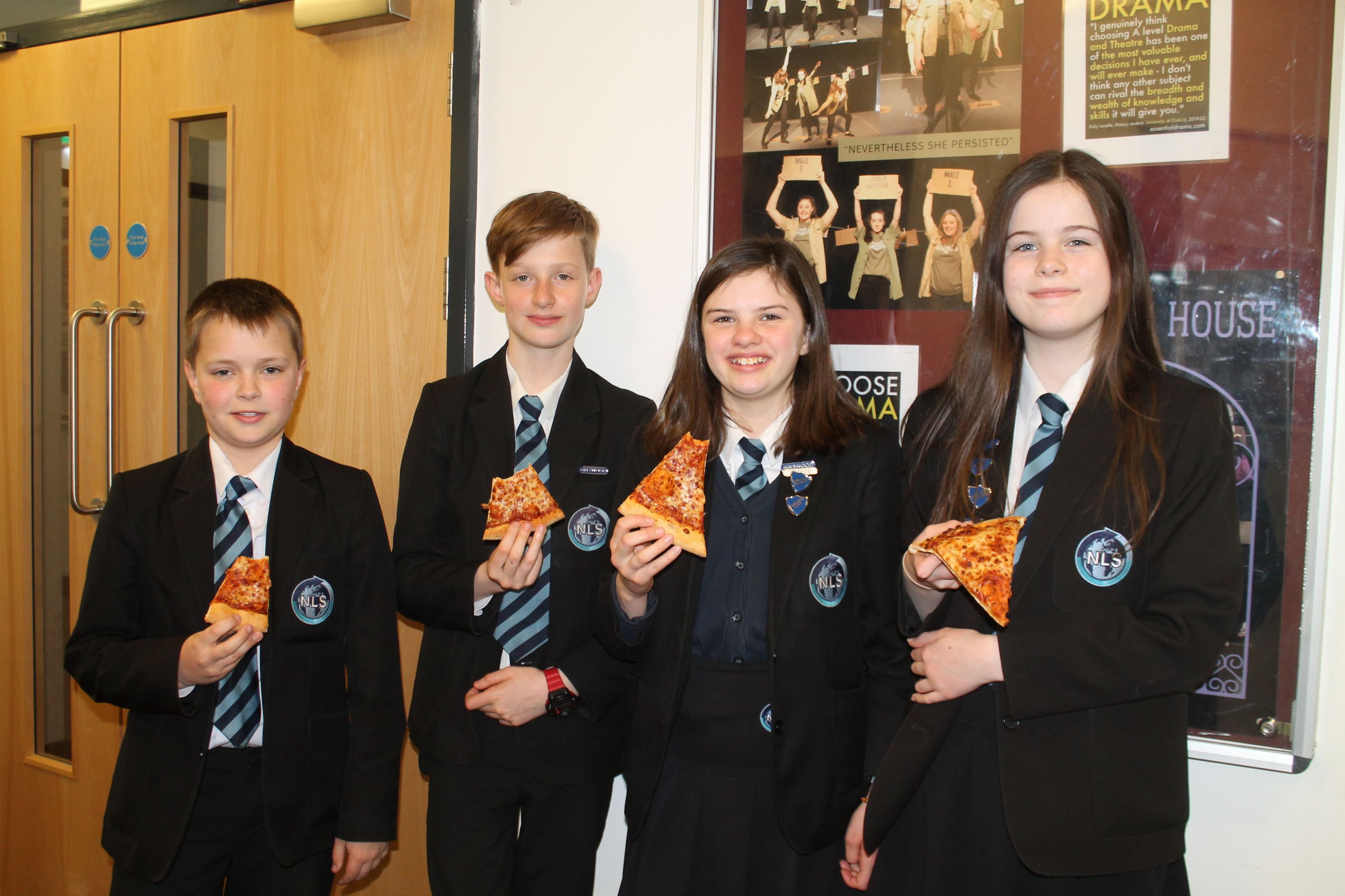 Four students enjoying pizza at the Spring 2024 Rewards Event