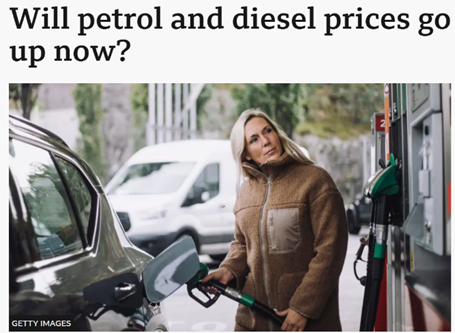 Photograph of a person fuelling a car at a petrol station, illustrating concerns about potential increases in petrol and diesel prices. The scene includes a fuel pump with green and black nozzles and a white van in the background.