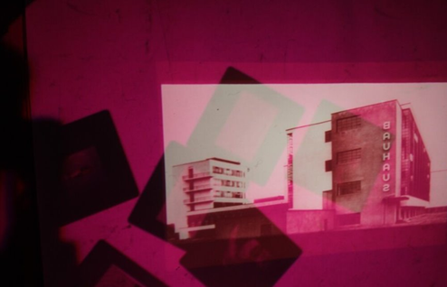 A pink and black picture of buildings