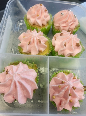 A group of cupcakes in a plastic container