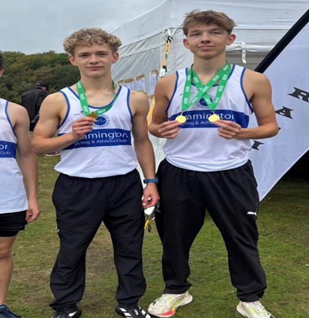 TWO BOYS HOLDING THEIR MEDALS