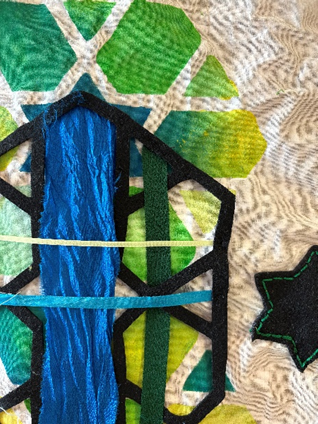 an example of work that is Stencil and applique which is  a mix of blue and greens 