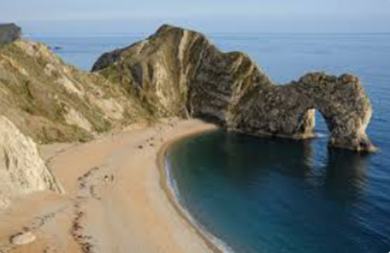 A beach with a rock arch - Durdle Door 
