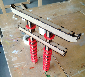 A wooden structure with red springs