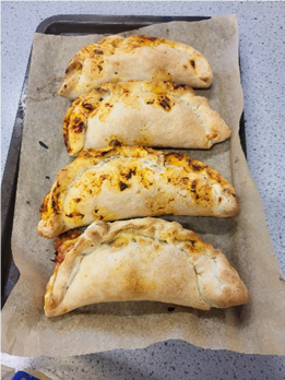 Four calzone on a tray