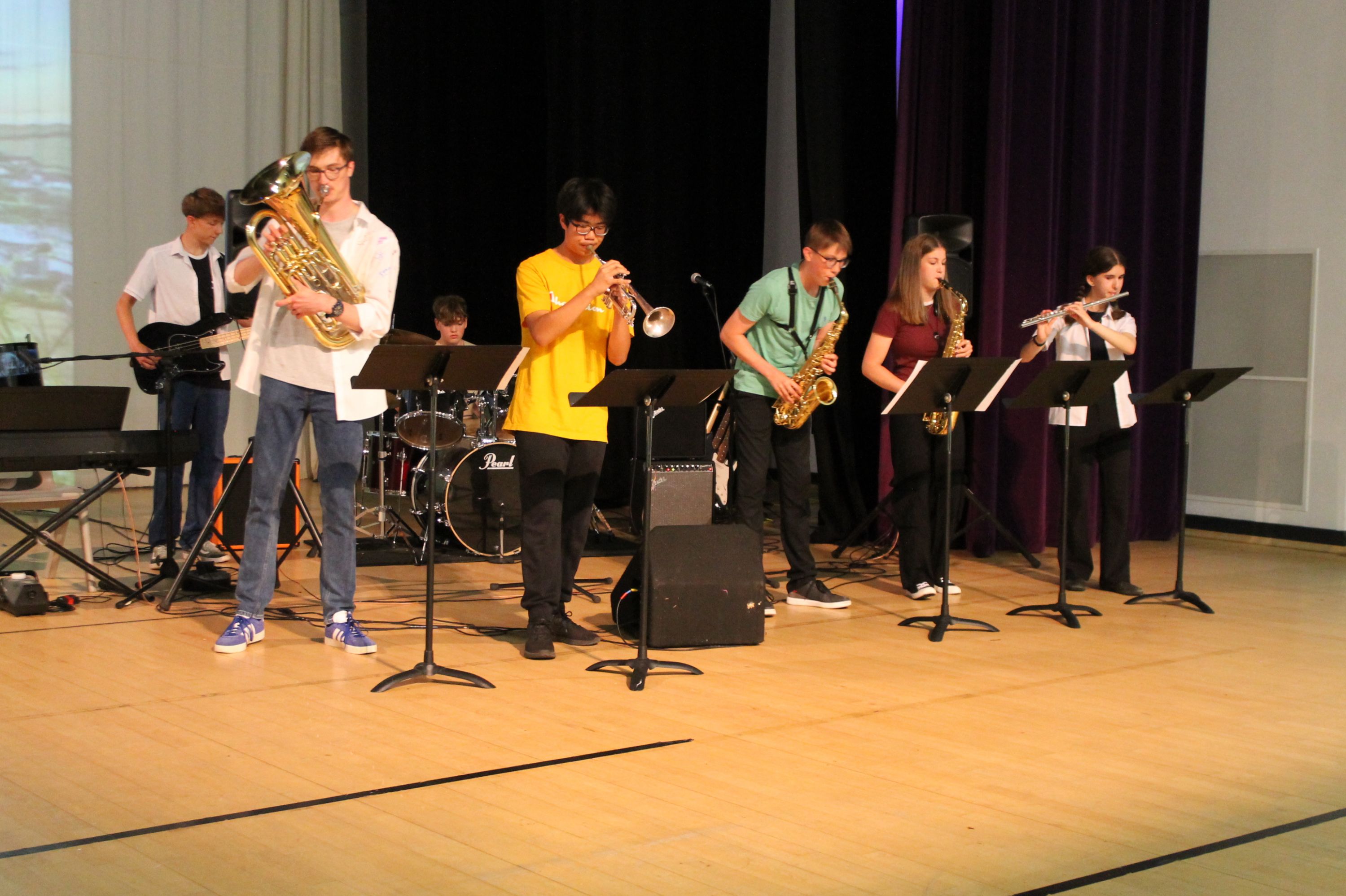 six students playing instruments at the summer concert 