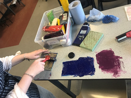 a student's hands in a textile class at a table