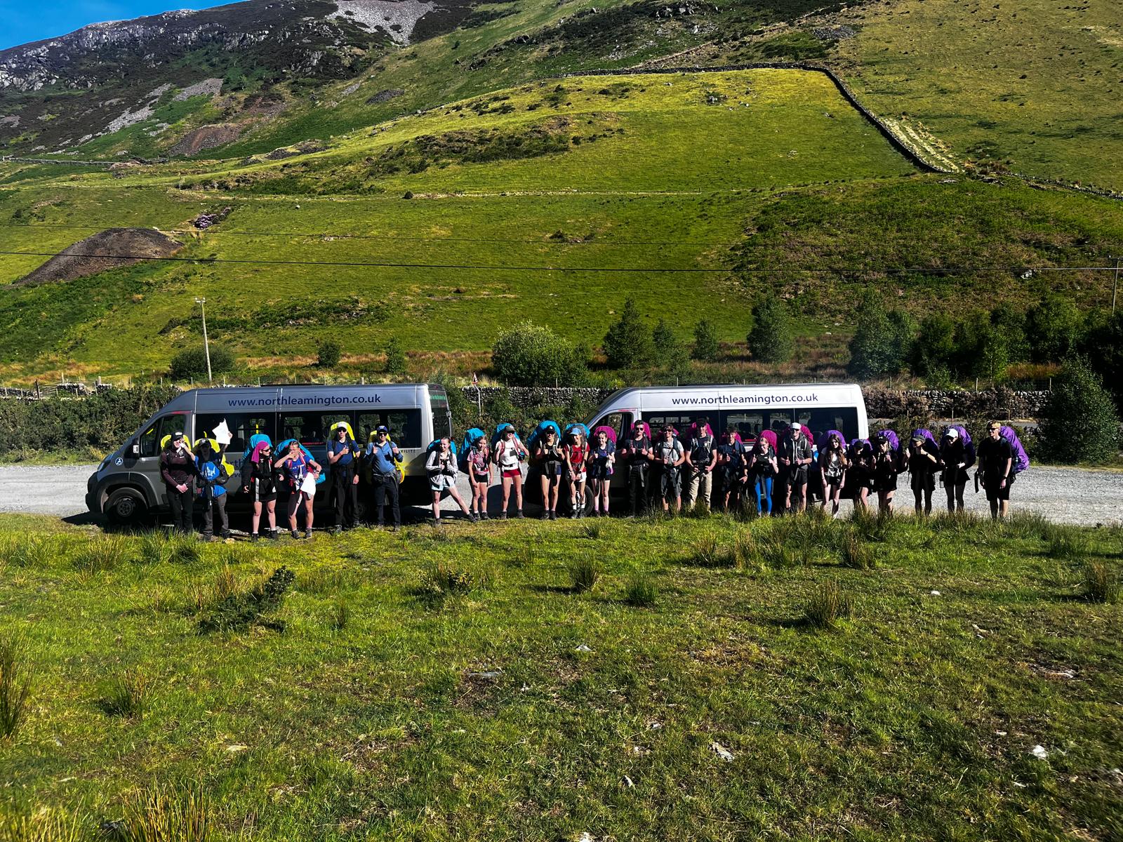 NLS Gold DofE STANDING IN FRONT OF TWO MINI BUSES