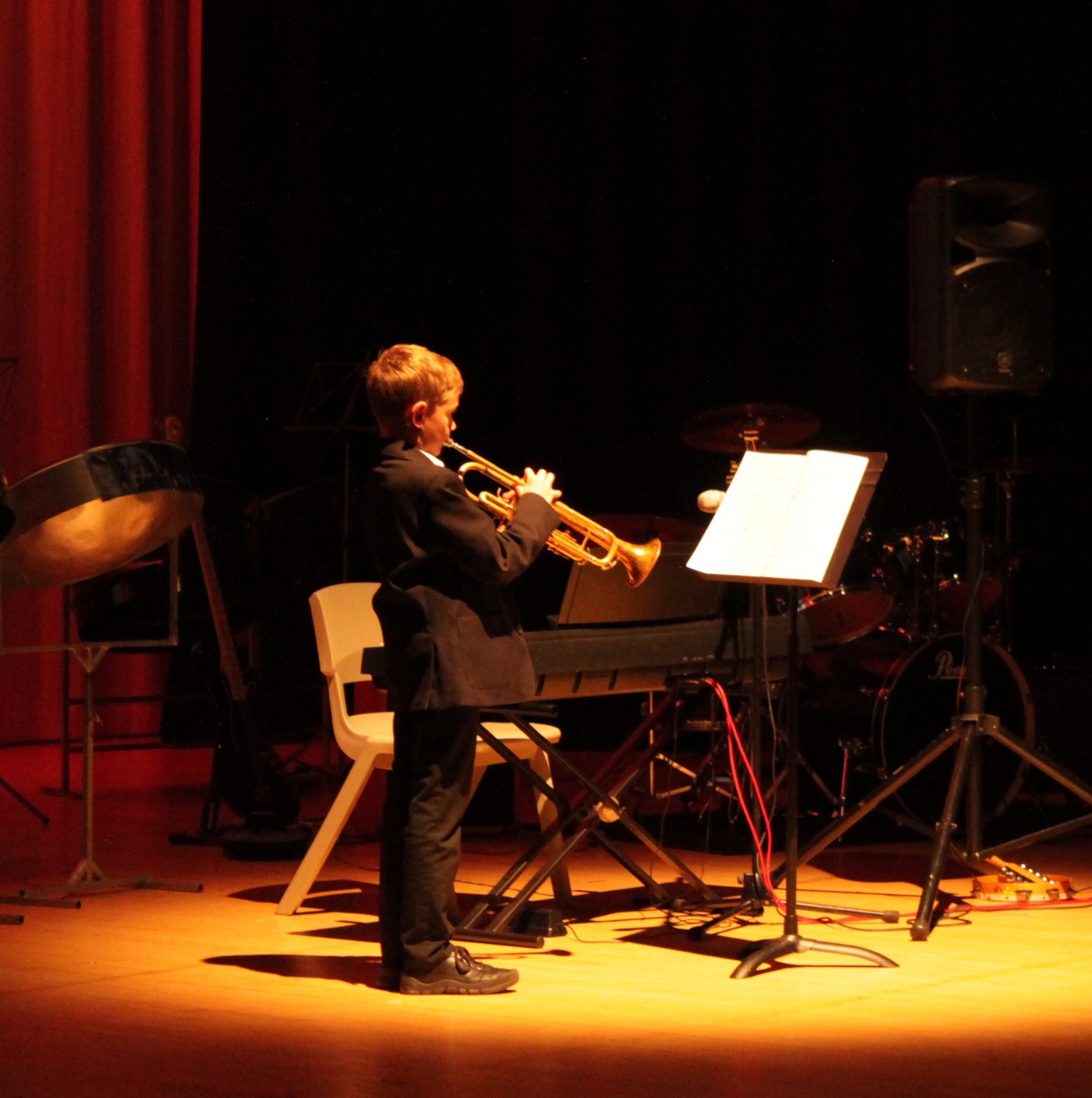 a student playing the trumpet at the music concert  