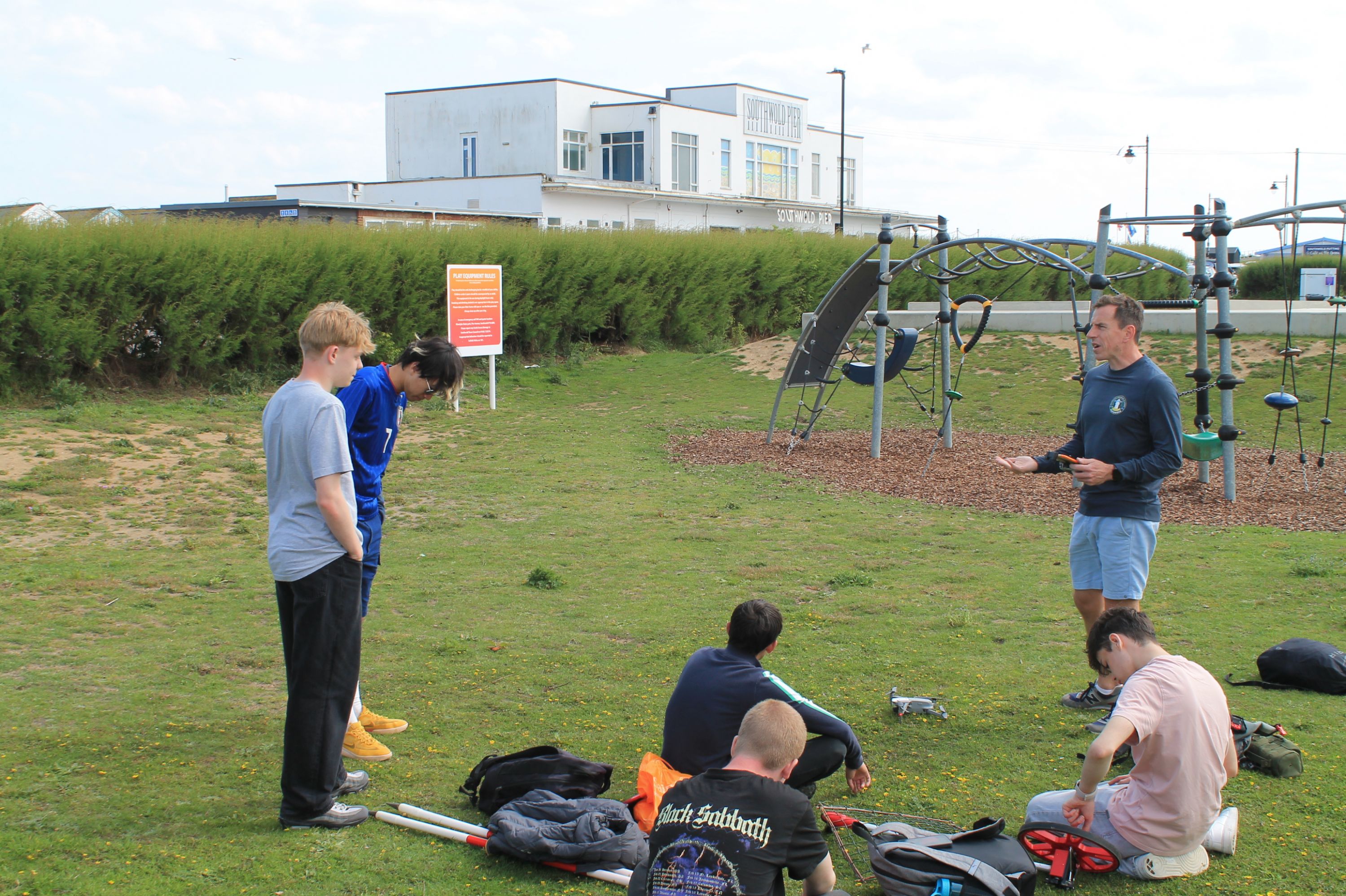 five students learning to fly a drone