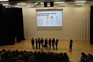 This image shows the International School Leaders presenting in assembly 