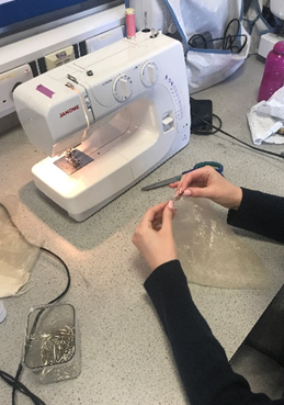 a student using a sewing machine