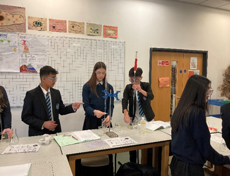 three students completing a titration practlcal