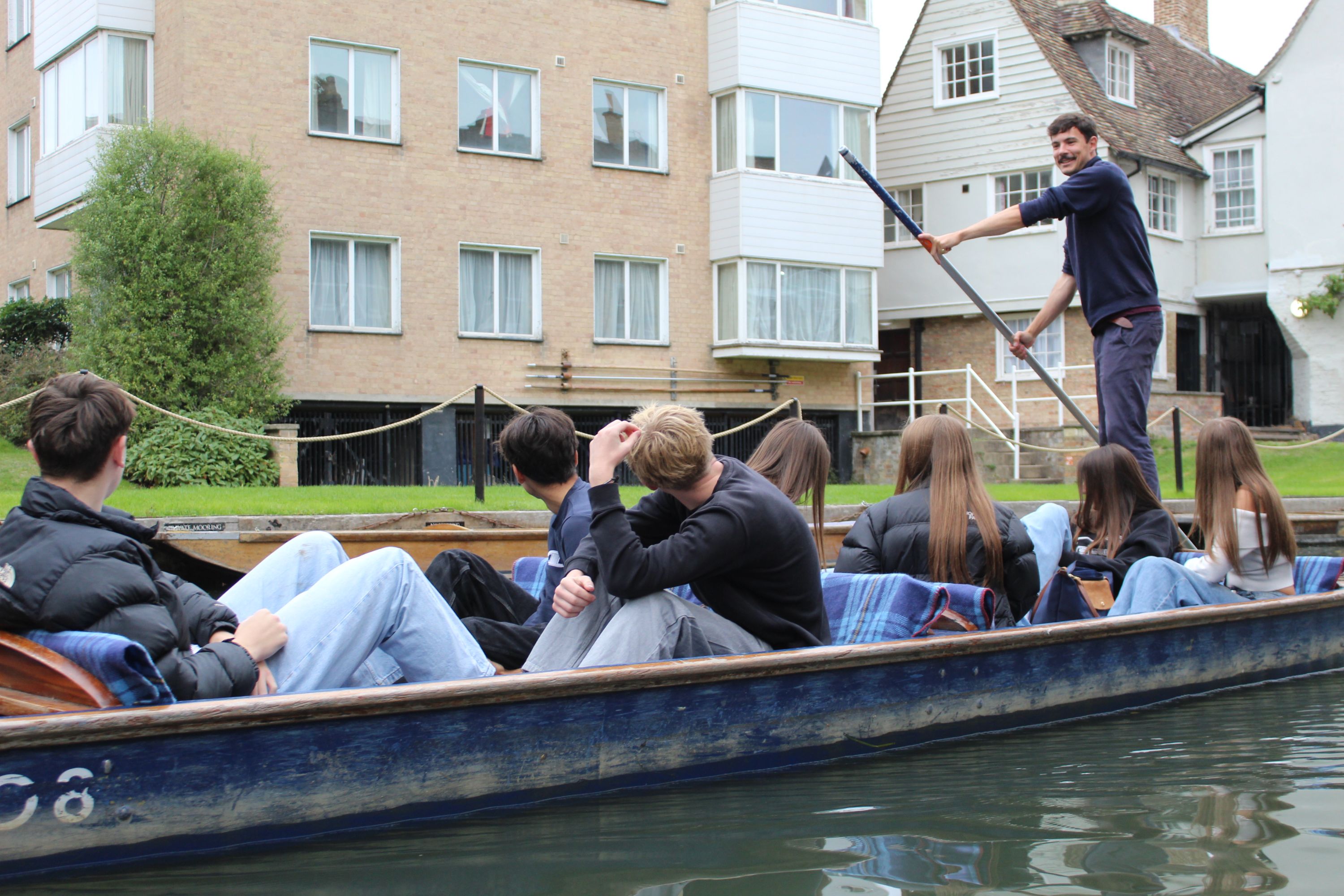 SEVEN STUDENTS ON A BOAT BEING PUNTED