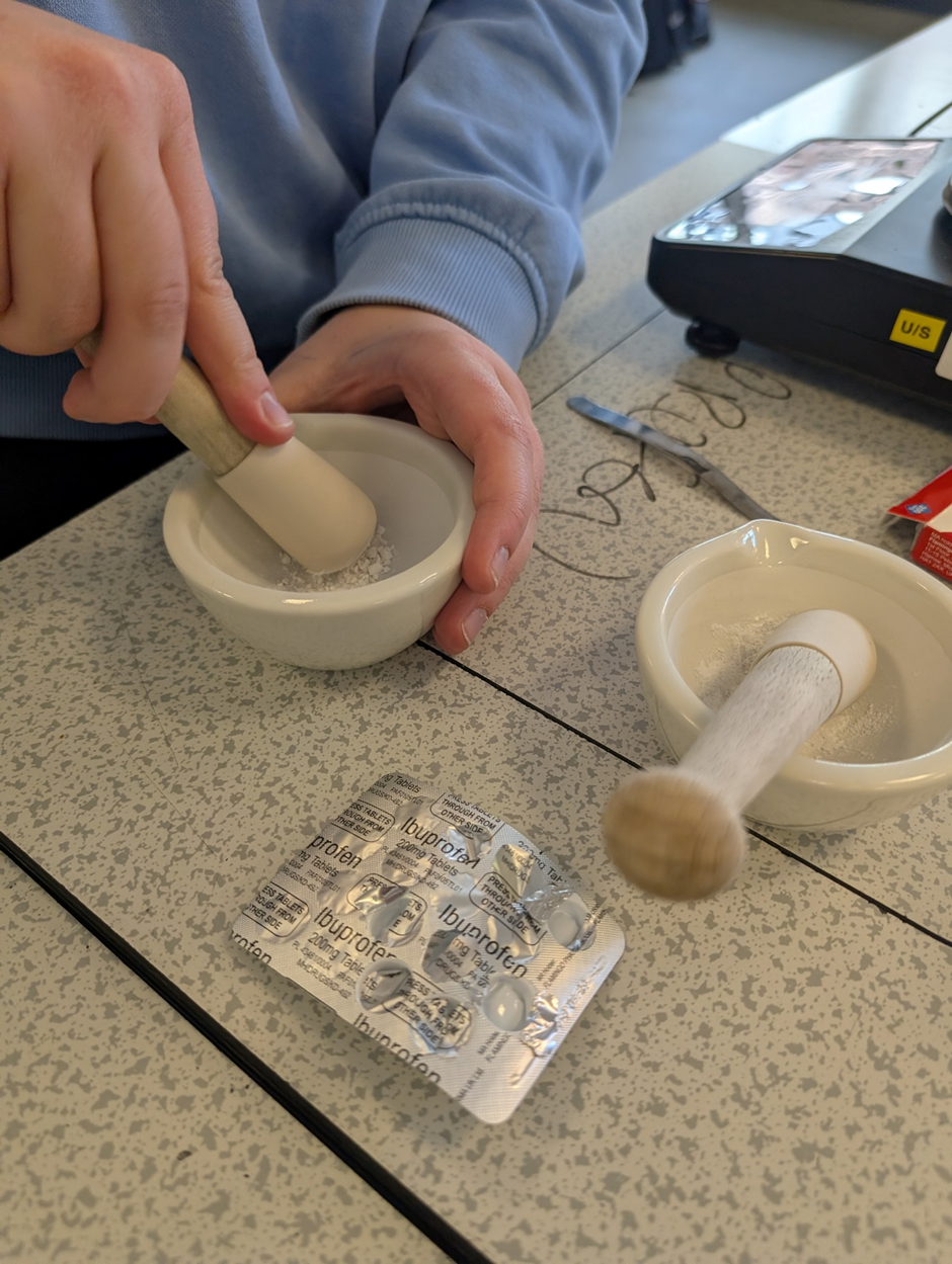 crushing anadin in a pestle and mortar