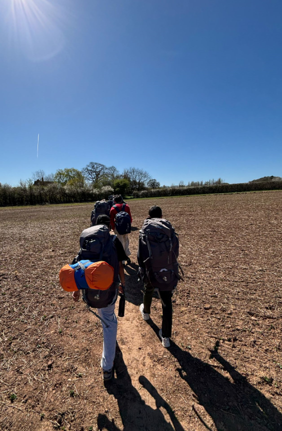 students hiking with backpacks