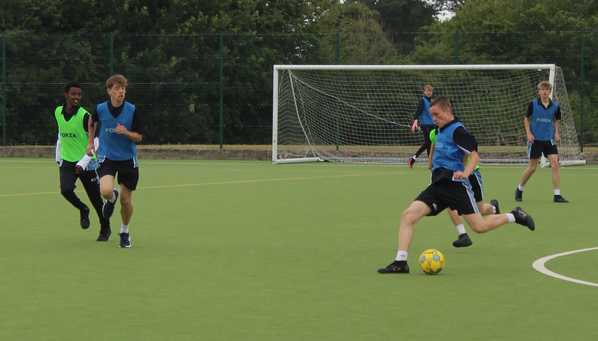 four boys playing football