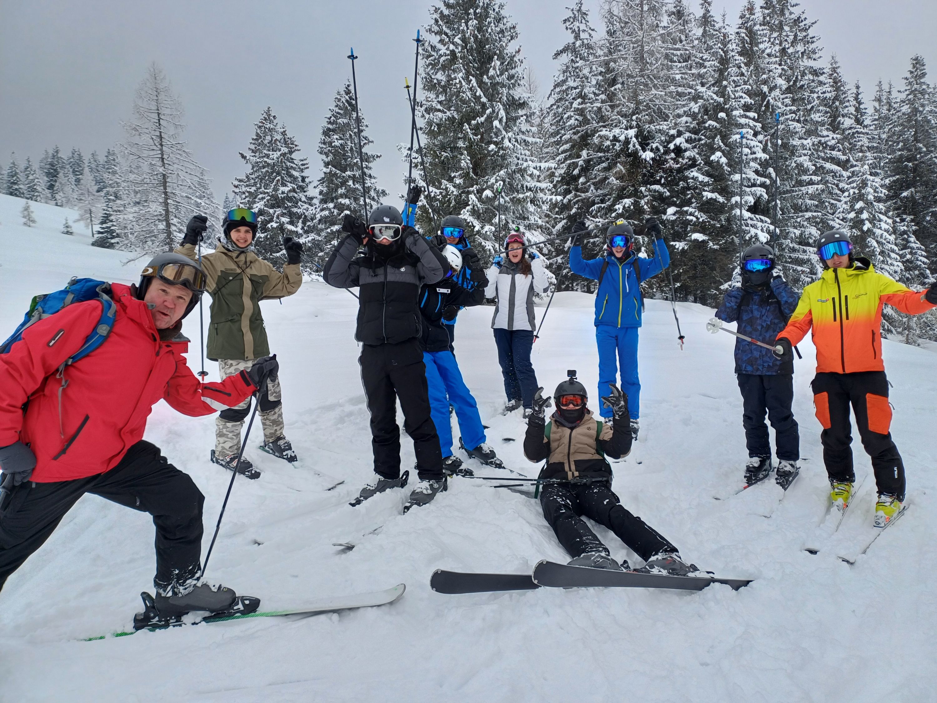 a group of nine skiers on the slopes