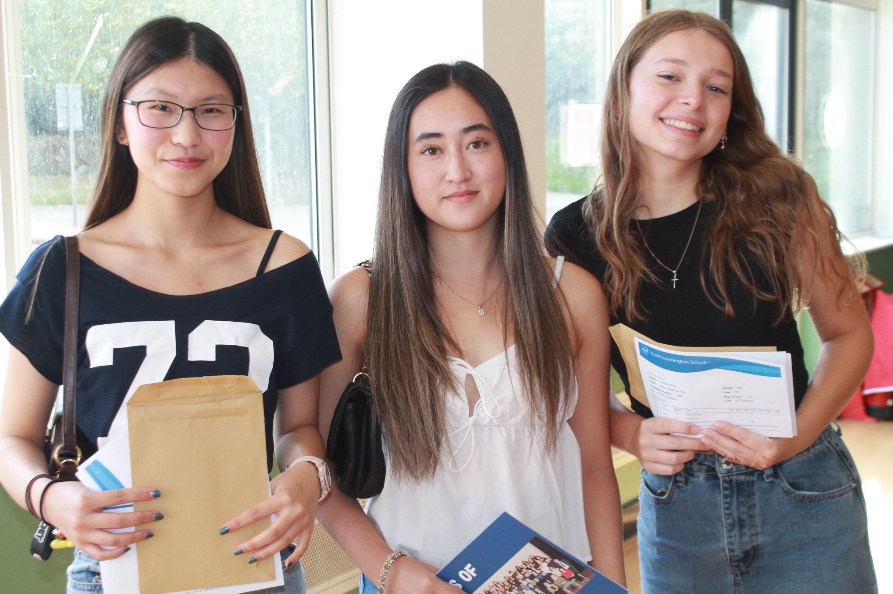 three students celebrating their A Level Results 