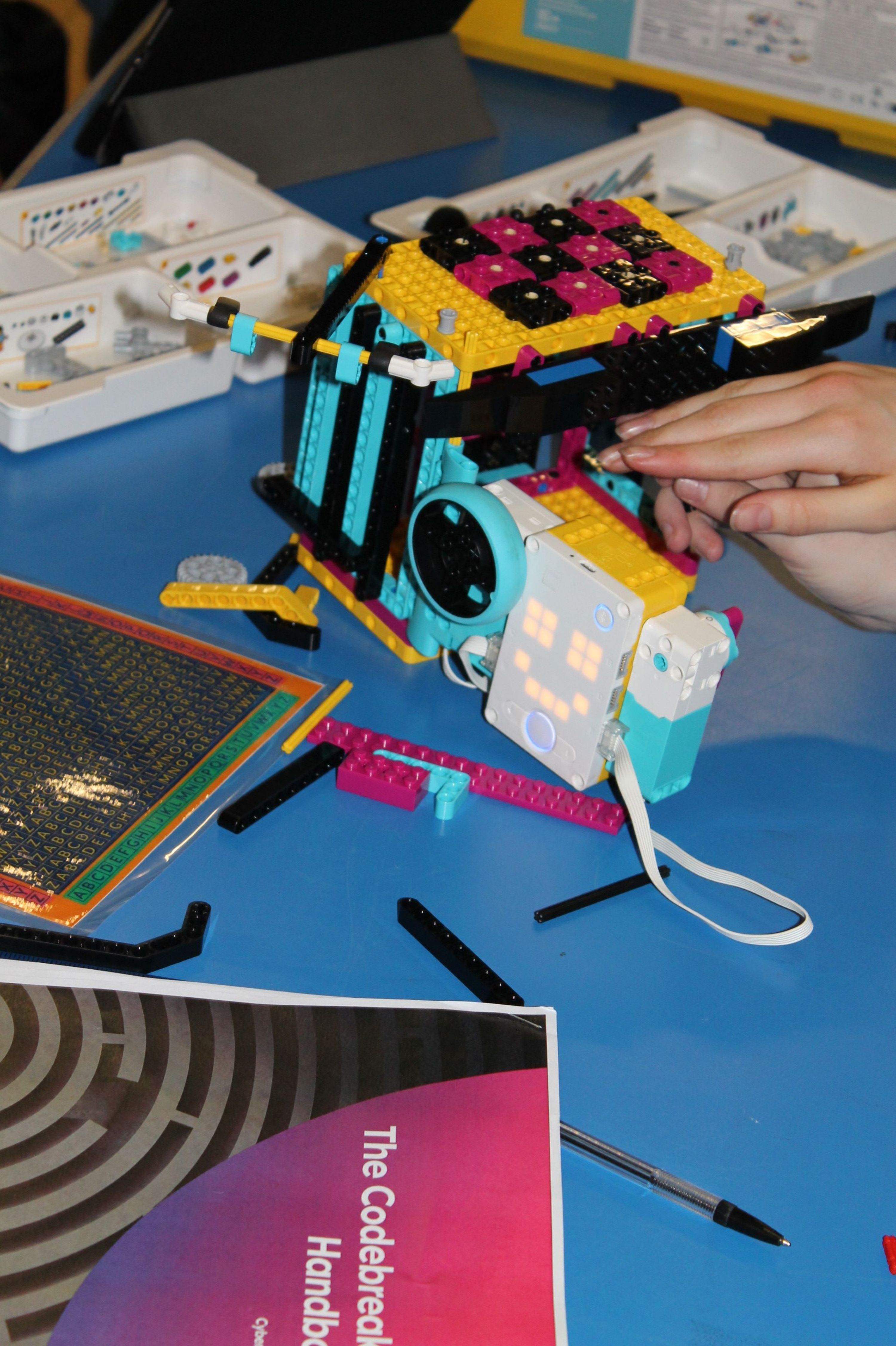 two hands building a model