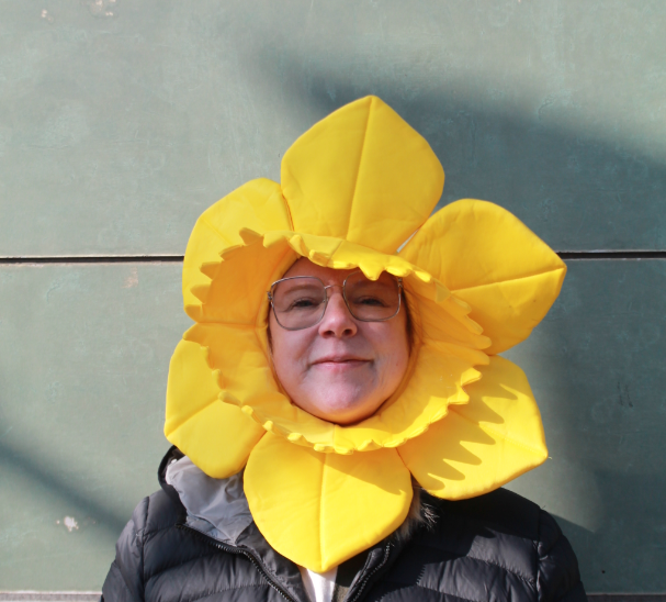 A member of staff dressed with a daffodil  to  celebrate world book day