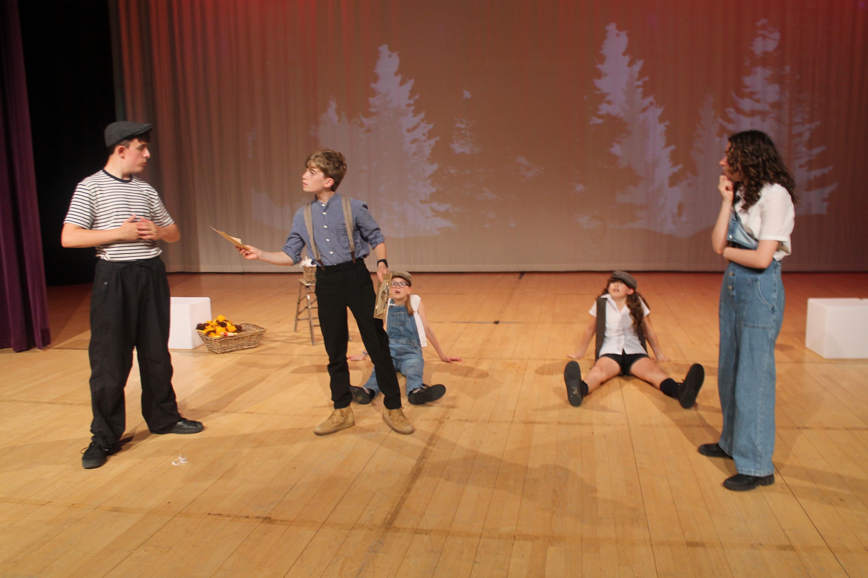 cast of the production in a scene