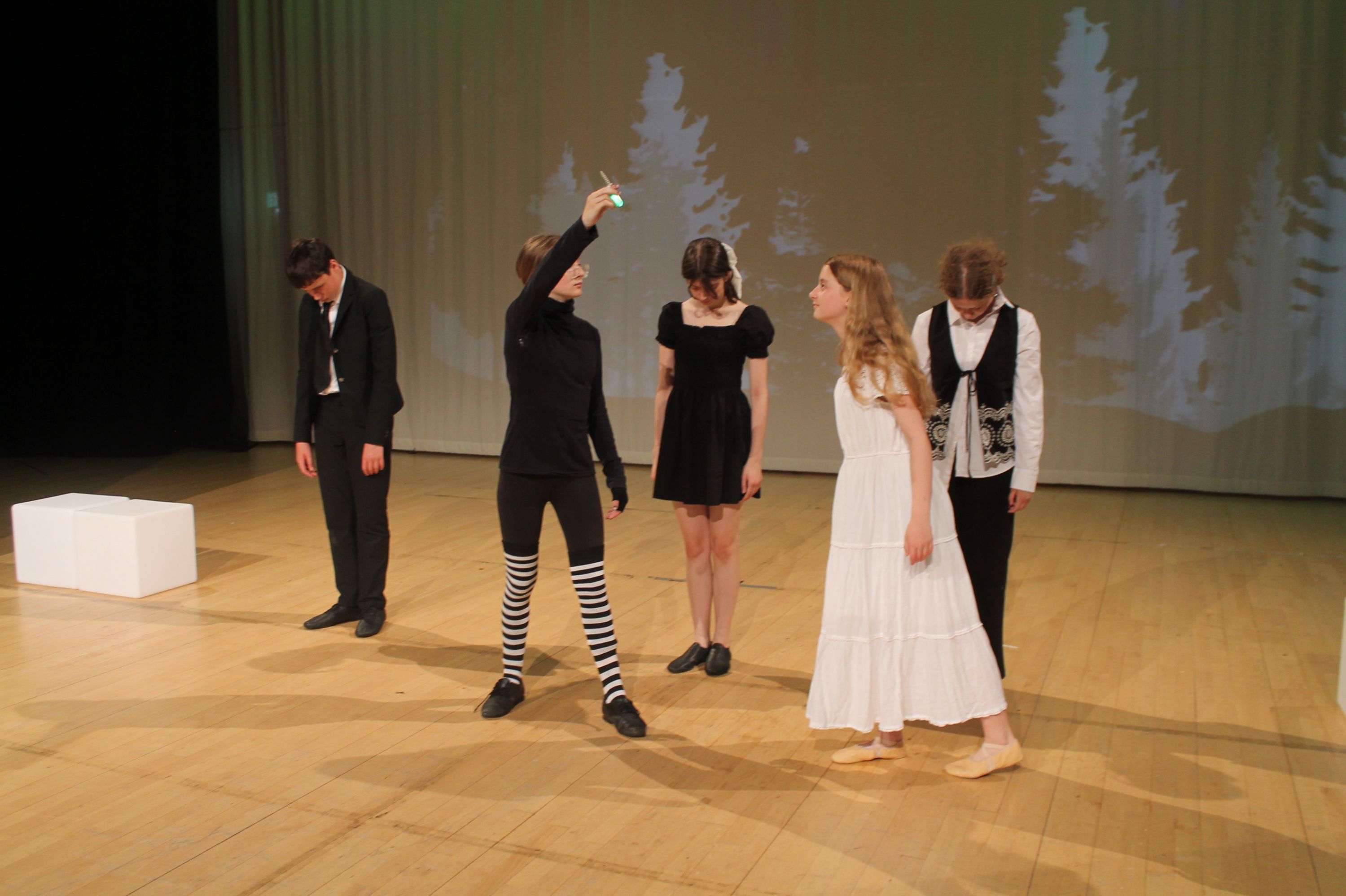  four of the cast of the production in a scene