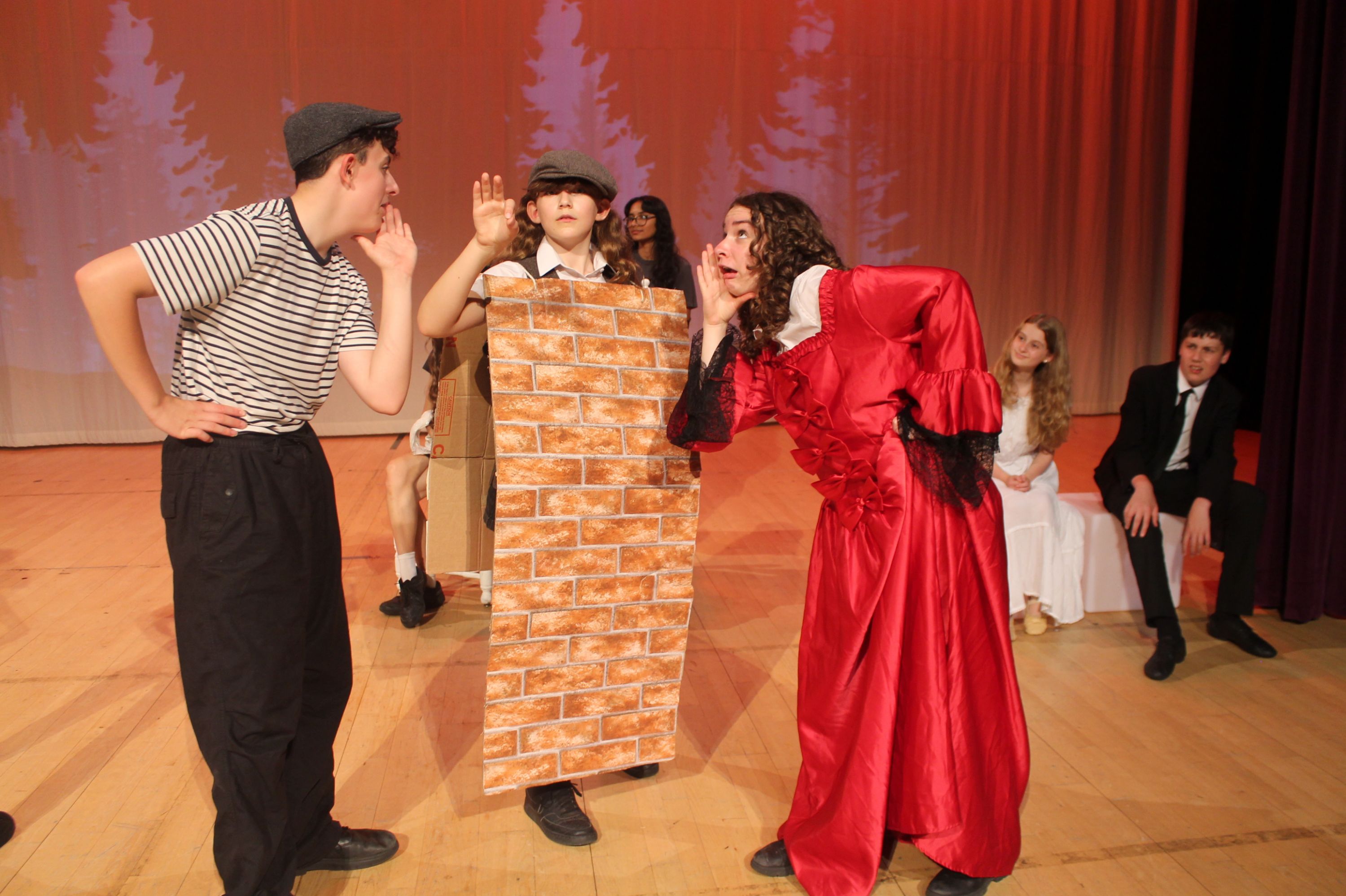 cast of the production in a scene