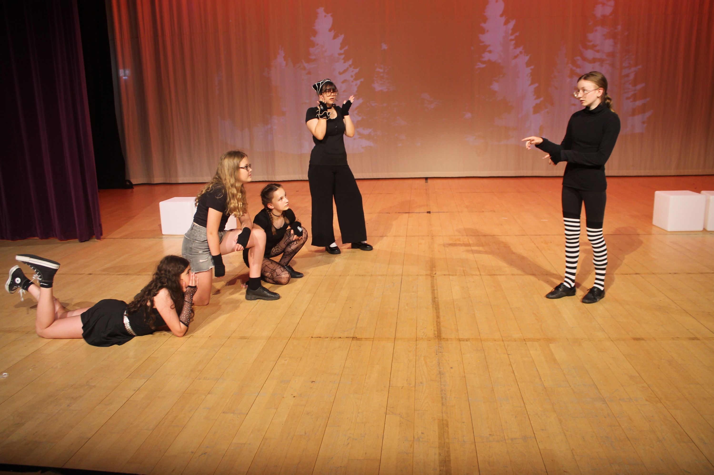 cast of the production in a scene