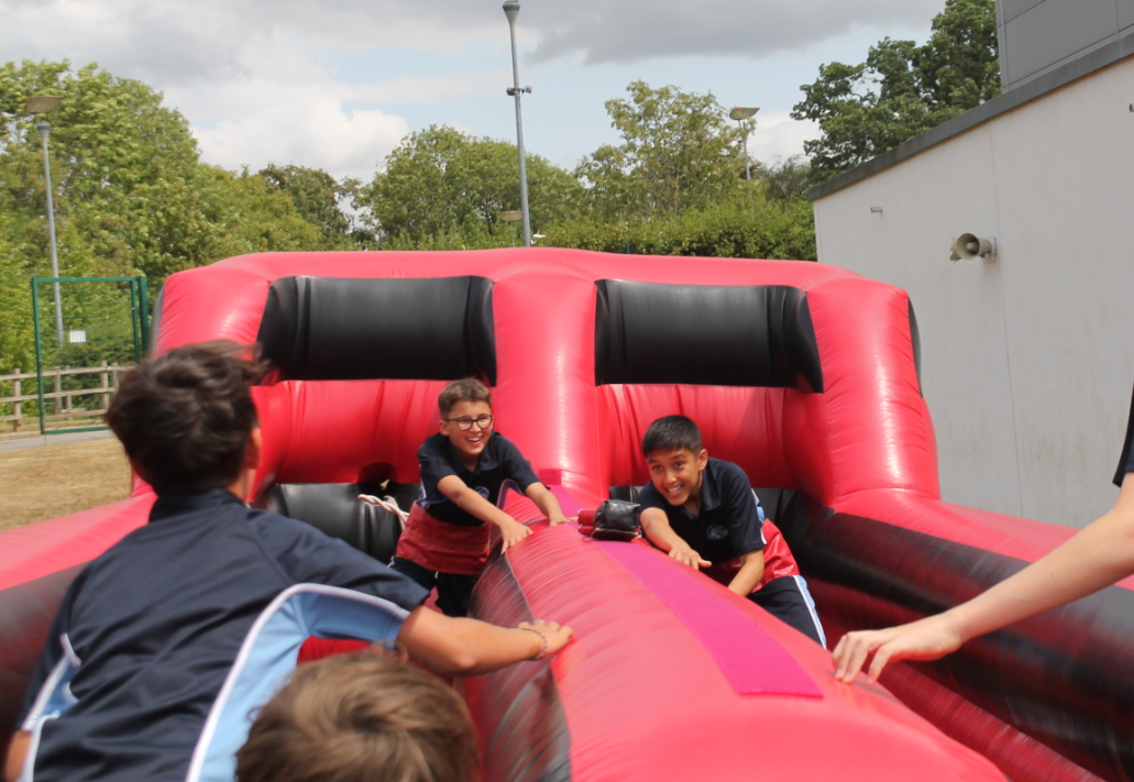 three students enjoying the inflatable