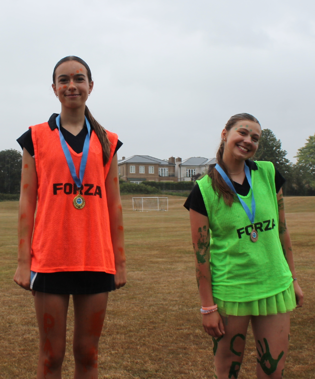 two girls with their medals after winning a race